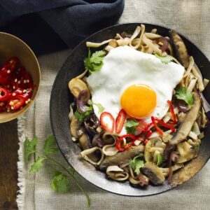 Mushroom noodle stir-fry with fried egg